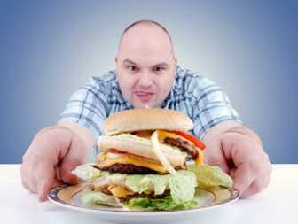 Man about to eat a giant hamburger.